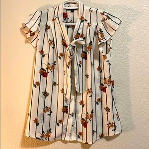 White blouse. Ties in front.